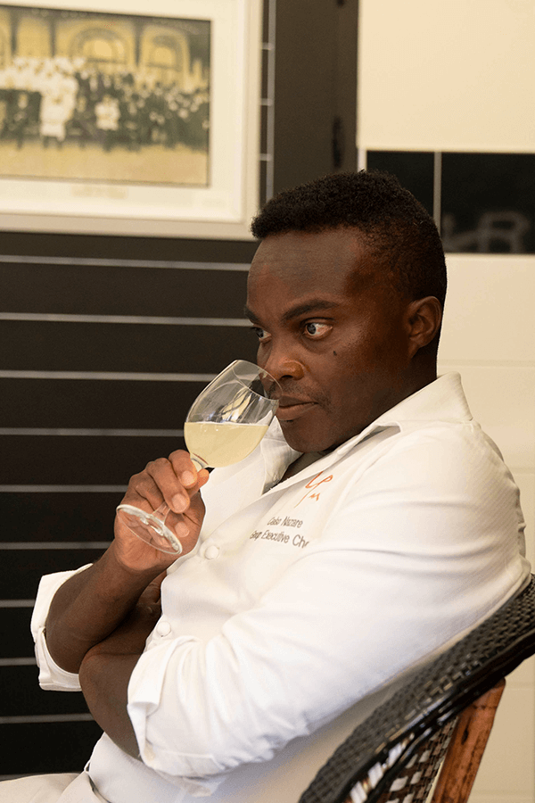 Chef Nazare Celso smelling a gless of evian® Sparkle.