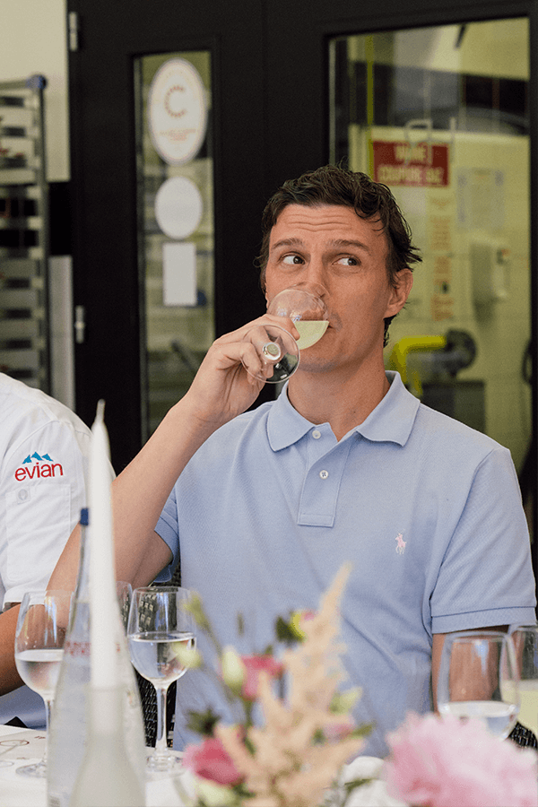 Chef Louis Pacquelin drinking a glass of evian® Sparkle.