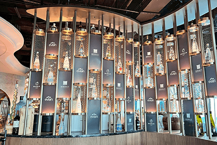 Bar with lots of Evian water bottles.