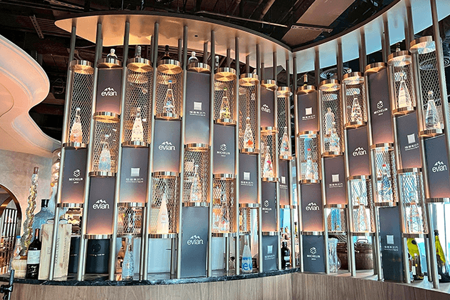 Bar with lots of Evian water bottles.